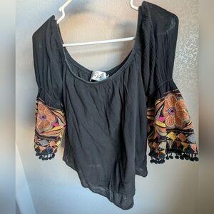 Off shoulder black top with embroidered sleeves